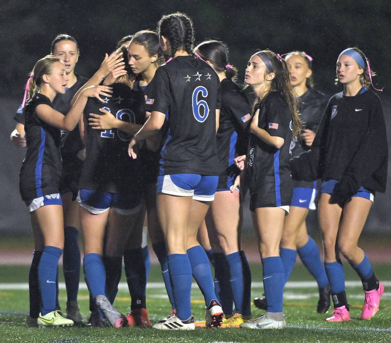St. Charles North High School teammates console each other after losing to Winnetka New Trier High School in the IHSA Class 3A championship game at North Central College in Naperville on Saturday, June 1, 2024.