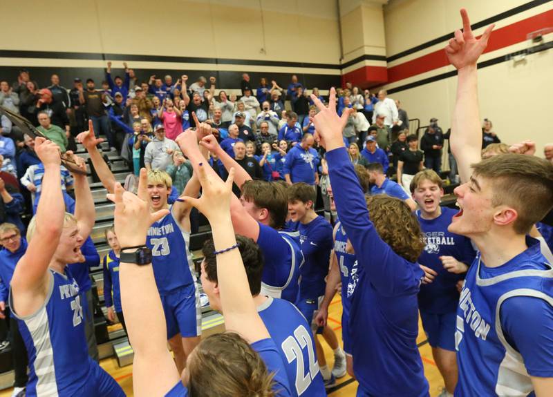 Members of the Princeton boys basketball team hoist the Class 2A Regional plaque after defeating Morrison during the Class 2A Regional final game on Friday, Feb. 23, 2024 at Erie-Prophetstown High School. Players and coaches held up the number three for three-peat Regional champions.