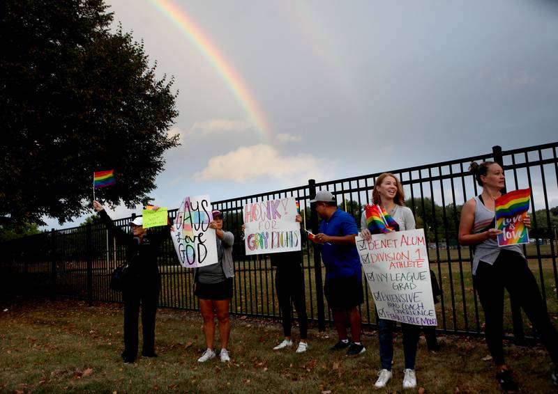 A natural rainbow occurred as Benet Academy parents, alumni and supporters demonstrate outside the Lisle Catholic school in response to administrators rescinding an employment offer to the new girls lacrosse coach after learning that she was gay. The school reportedly hired Amanda Kammes, a Benet alum and head girls varsity lacrosse coach at Montini Catholic High School in Lombard, but rescinded the offer when her paperwork included her wife’s name as her emergency contact.
