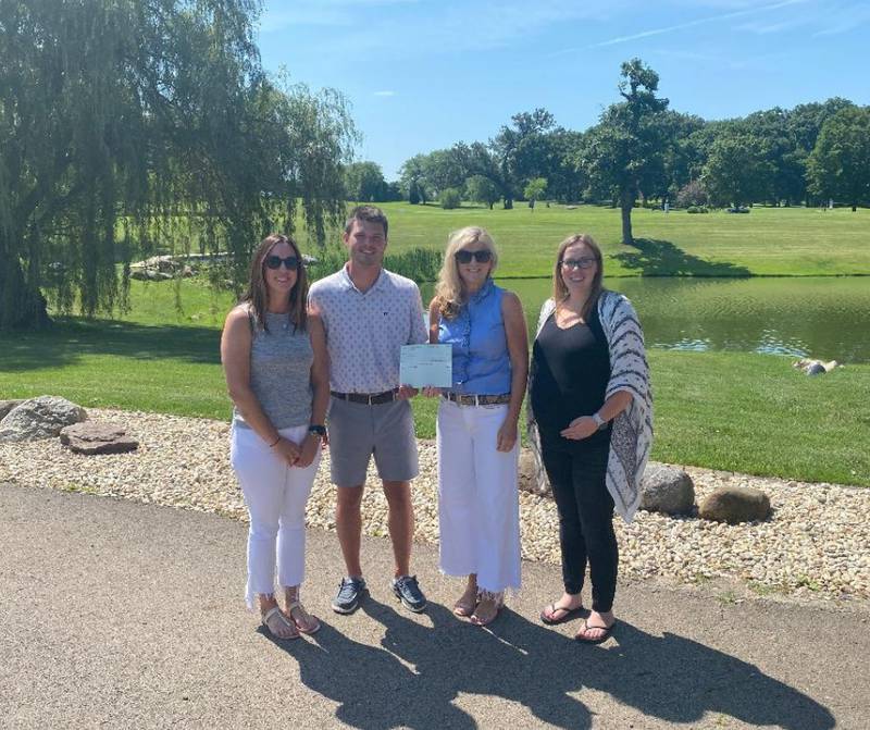 (From left) Spencer Luecke, board president; Nate Rodriguez, Julie Sloan, executive director; and Melyssa Garten, vice president.