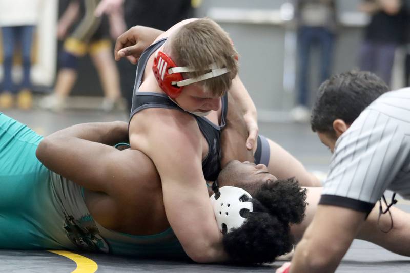 Marian’s Jimmy Mastny pins Woodstock North’s David Randecker at 215 pounds in boys wrestling IHSA Class 2A Regional championship bout action on Saturday, Jan. 31, 2026, at Harvard High School in Harvard.