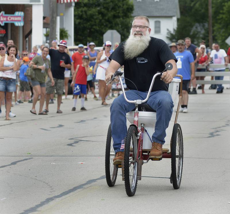 Dan O’Malley rides the General Pee during the annual Toilet Bowl Races as part of the towns 4th of July celebration.