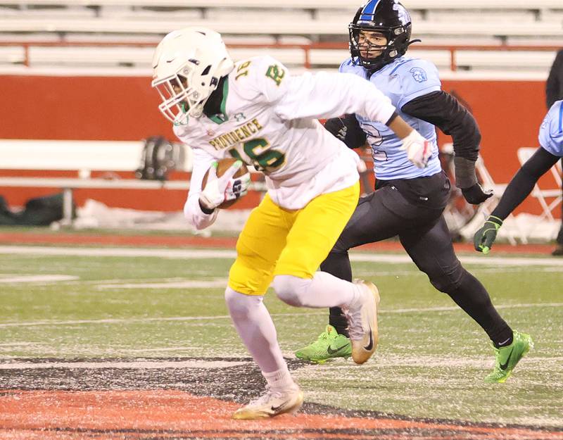 Providence Catholic's DeAngelo Coates runs with the ball past St. Francis's Peyton Shipley during the Class 5A State championship on Tuesday, Dec. 2, 2025 in Hancock Stadium at Illinois State University in Normal.