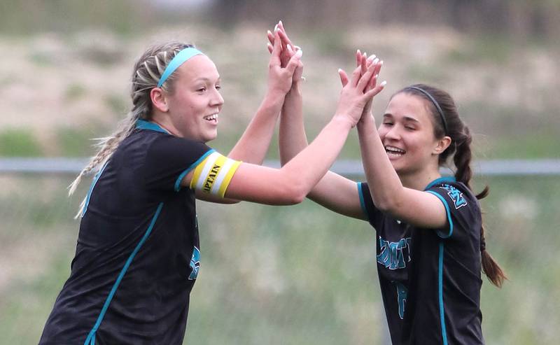 Woodstock North's Katelynn Ward is congratulated by teammate Charlotte Noshay after scoring a goal during their IHSA Class 2A regional game against Sycamore Tuesday, May 17, 2022, at Burlington Central High School.