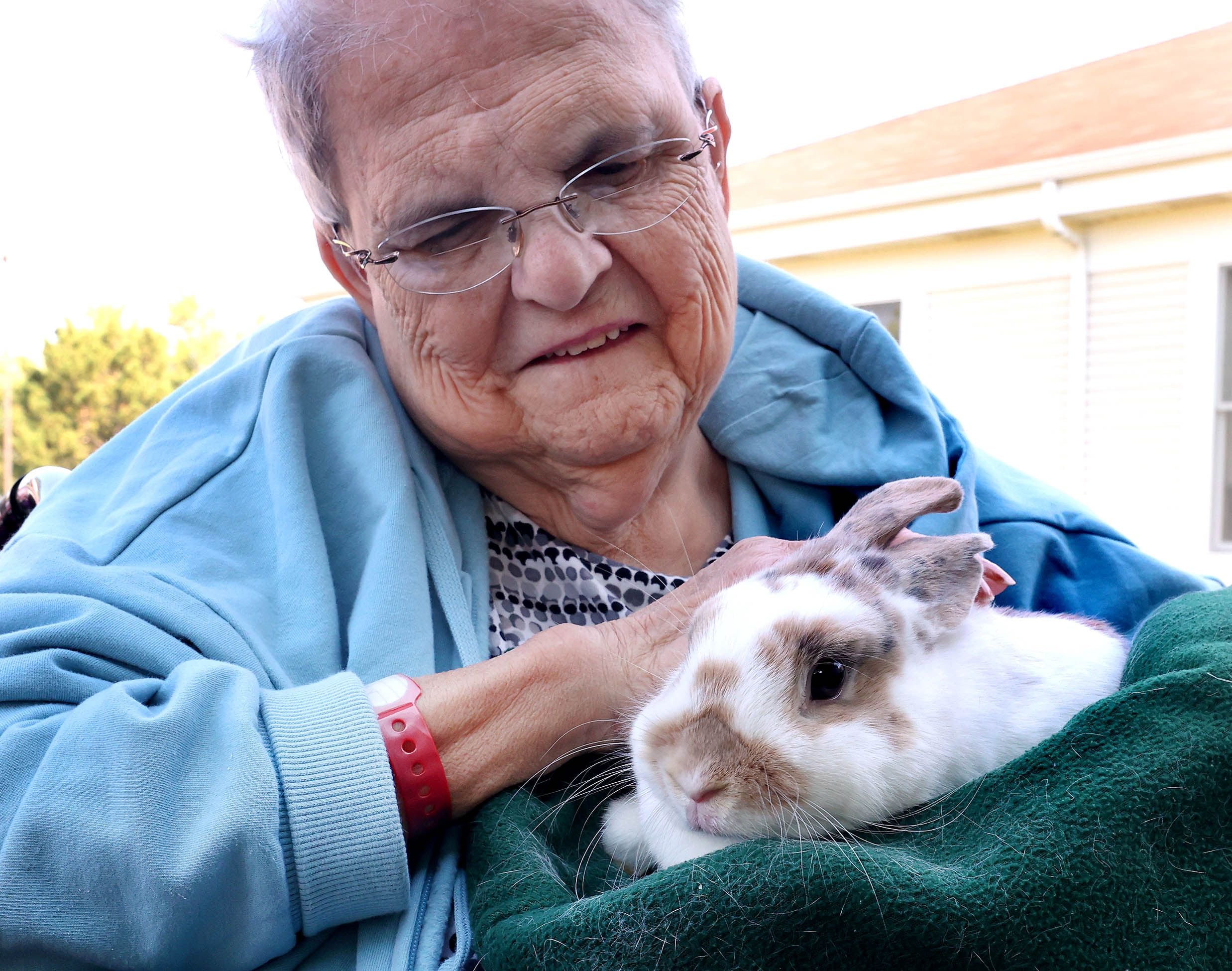DeKalb County Rehab and Nursing Center resident Anna Barnes pets a rabbit during a visit from Kate’s Kritters Mobile Petting Zoo Thursday, Sept. 18, 2025, at the facility in DeKalb.