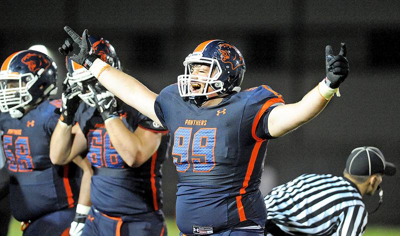 Oswego's Austin Hamiti (99) celebrates after the Panther defense stopped Providence on fourth down for the win during Friday's non-conference game at Oswego.