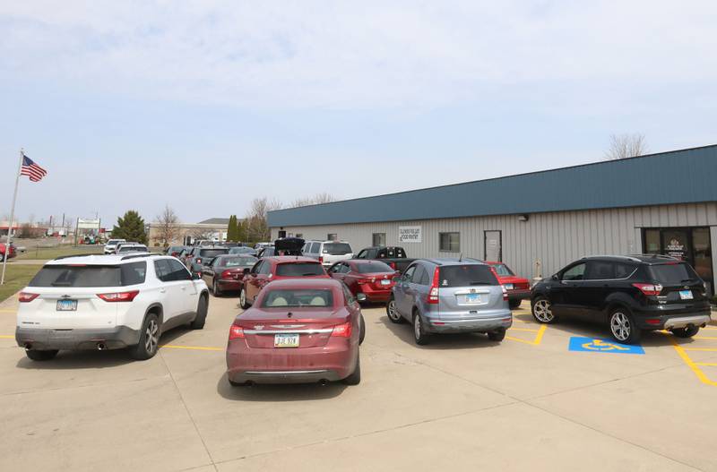 A long line of cars wait for their turn to load during the Easter distribution on Wednesday, March 25, 2026 at the Illinois Valley Food Pantry in Peru.