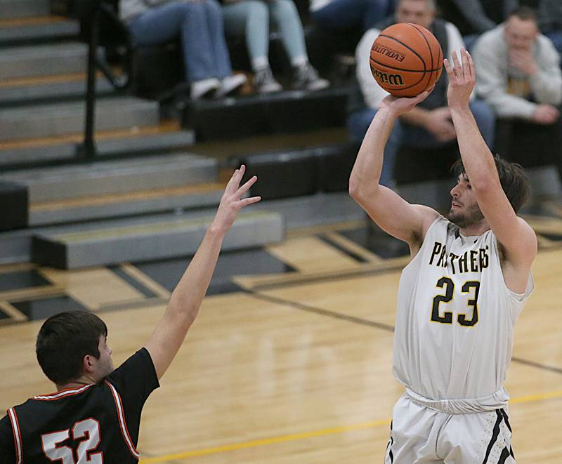 Putnam County's Jackson McDonald shoots a three-point basket over Roanoke-Benson's Braden Tomlinson during the Tri-County Conference Tournament on Tuesday, Jan. 24, 2023 at Putnam County High School.