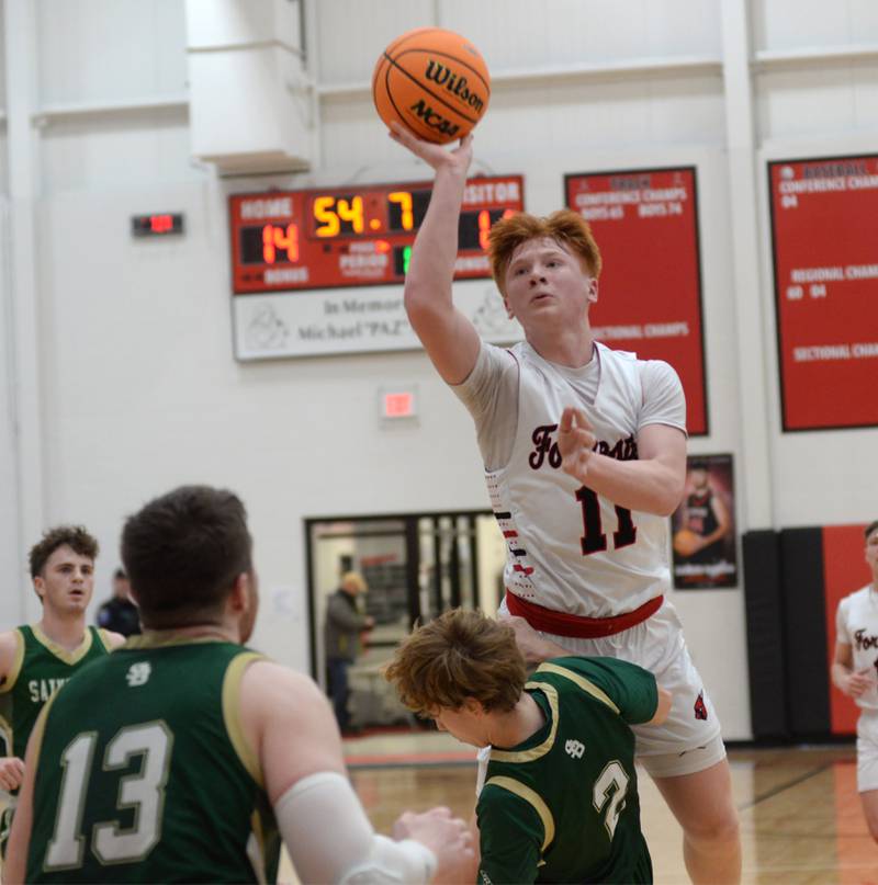 Forreston's Connor Politsch (11) shoots as Peru St. Bede's Kaden Nauman (2) draws the charge on Wednesday, Feb. 26, 2025 at the 1A Amboy Regional at Amboy High School.