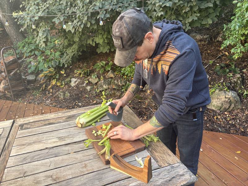 Army veteran and Trout Valley resident Doug Katz demonstrates the ergonomic uses of the Nulu kitchen knife specially designed for people with mobility disabilities.