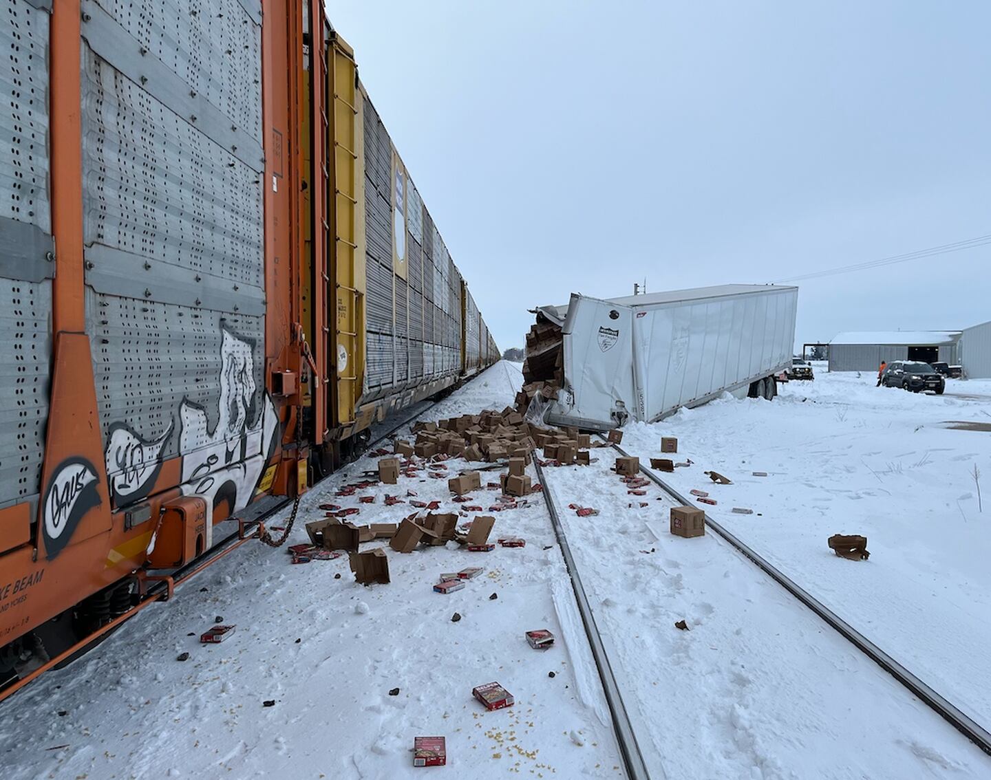 A semi from Mexico hauling a load of Hamburger Helper got hung up on the snowy tracks at the Willow Road crossing east of Franklin Grove and was struck by a Union Pacific train, sending boxes spilling in the snow. The driver jumped free.