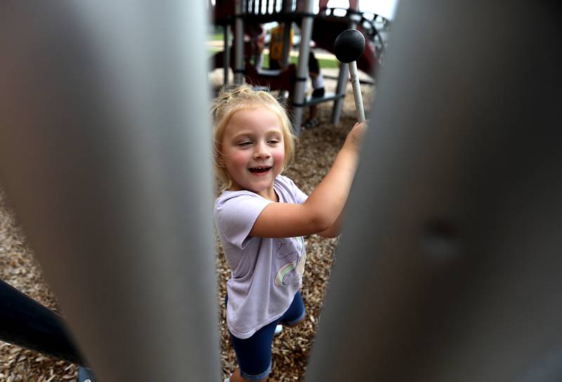 Preschool Autumn Hayes plays a musical instrument on the playground during the first day of school on Tuesday, Aug. 12, 2025, at District 300's Westfield Community School in Algonquin.