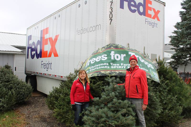 Wendy and George Richardson stand with about 30 of their trees that will be donated to Trees for Troops.