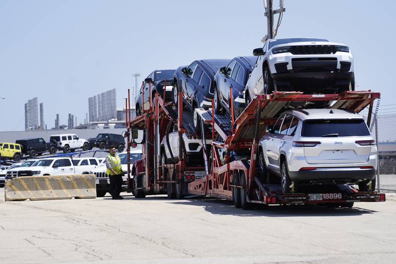 A transport carrying new cars arrives at a Stellantis facility on Monday, July 10, 2023, in Belvidere. Ill. On Thursday, the Commerce Department issues its first of three estimates of how the U.S. economy performed in the second quarter of 2023. (AP Photo/Charles Rex Arbogast)