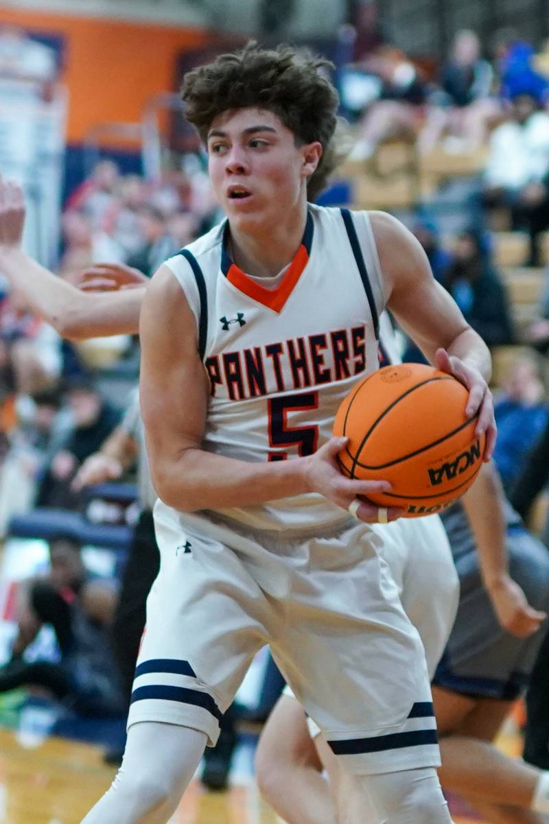 Oswego’s Mariano Velasco (5) rebounds the ball during a basketball game against Oswego East at Oswego High School on Tuesday, February 18, 2025.