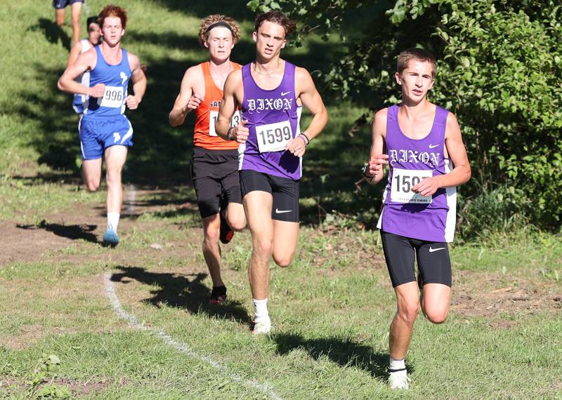 Dixon's Aaron Conderman comes down a hill just ahead of teammate Jack Johnson Tuesday, Aug. 30, 2022, during the Sycamore Cross Country Invitational at Kishwaukee College in Malta.