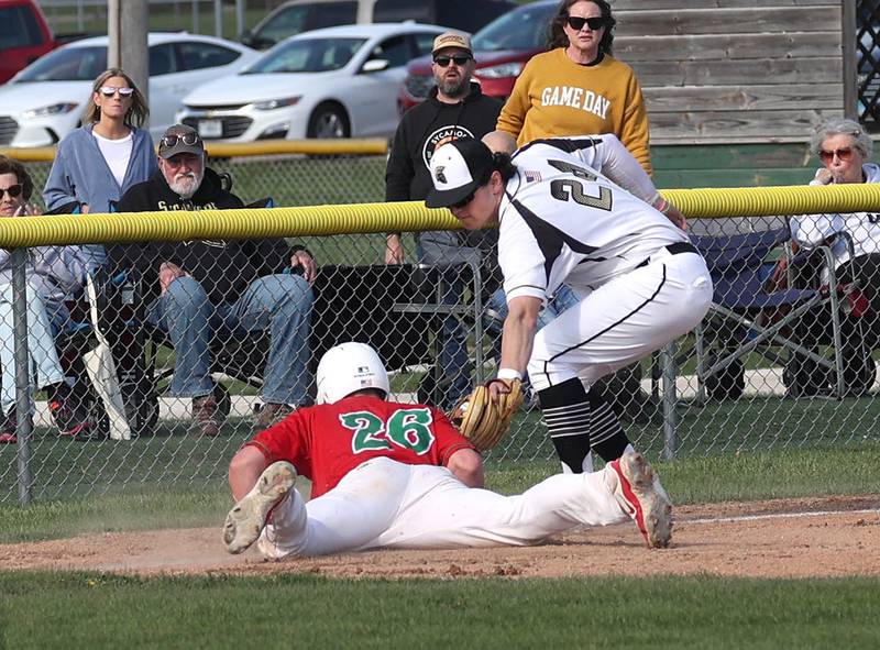 La Salle-Peru's Griffin May slides in safely at third as Sycamore's Jack Block applies the tag Wednesday, April 23, 2025, during their game at the Sycamore Community Sports Complex.