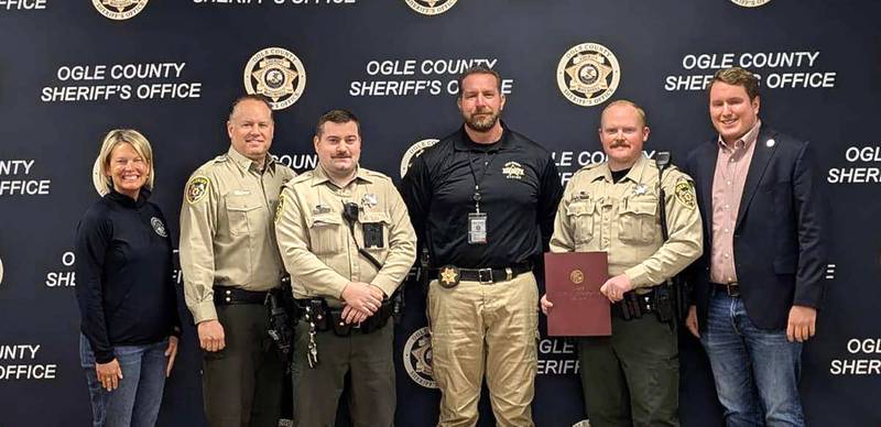 Illinois Representatives Tony McCombie (far left) and Brad Fritts (far right) presented members of the Ogle County Sheriff’s Office with Illinois House Resolutions honoring the bravery they exhibited on June 12, 2024. Pictured left to right are: McCo,mbie, Ogle County Sheriff Brian VanVickle, Deputy Tad Dominski, Lt. Jason Ketter, and Deputy Tyler Carls.