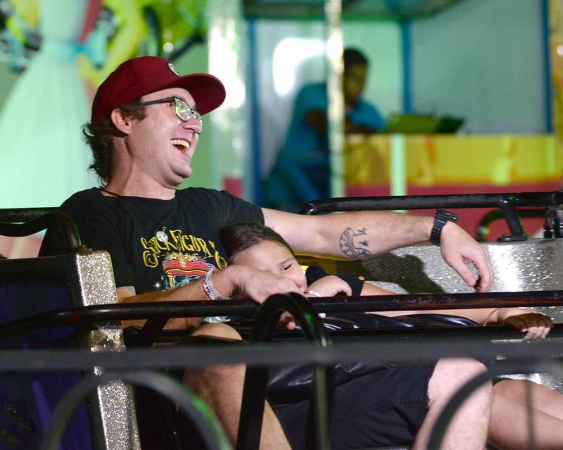 Christian Grogan and his niece, Novalee Currier, 7, of Mt. Morris, take a spin on one of the carnival rides at the Ogle County Fair on Thursday, Aug. 1, 2024.