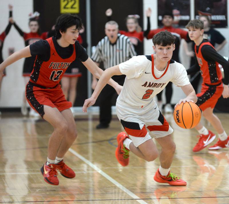 Amboy's Eddie Jones (2) drives to the basket as Fulton's Caden Wilkin (12) follows during a Friday, Jan. 17, 2025 game at Amboy High School.