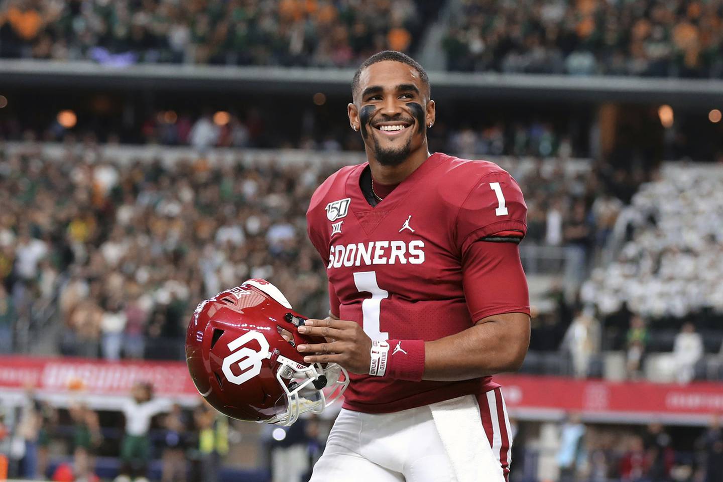 Quarterback Jalen Hurts smiles on the sidelines before Oklahoma played Baylor for the Big-12 championship, in Arlington, Texas in December 2019.