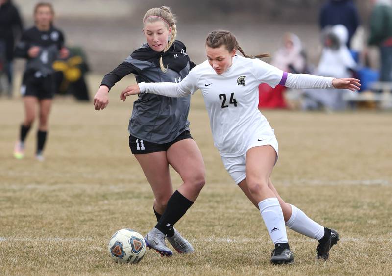 Sycamore's Ella Shipley and Kaneland's Madie Nitsche fight for possession during their game Monday, April 4, 2022, at Kaneland High School in Maple Park.