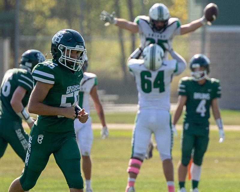 Landon Boggio (55) of St. Bede runs across field as Dwight players celebrate their touchdown on Saturday, Oct. 4, 2025 at Captain Thomas J. Heitmann field in Peru.