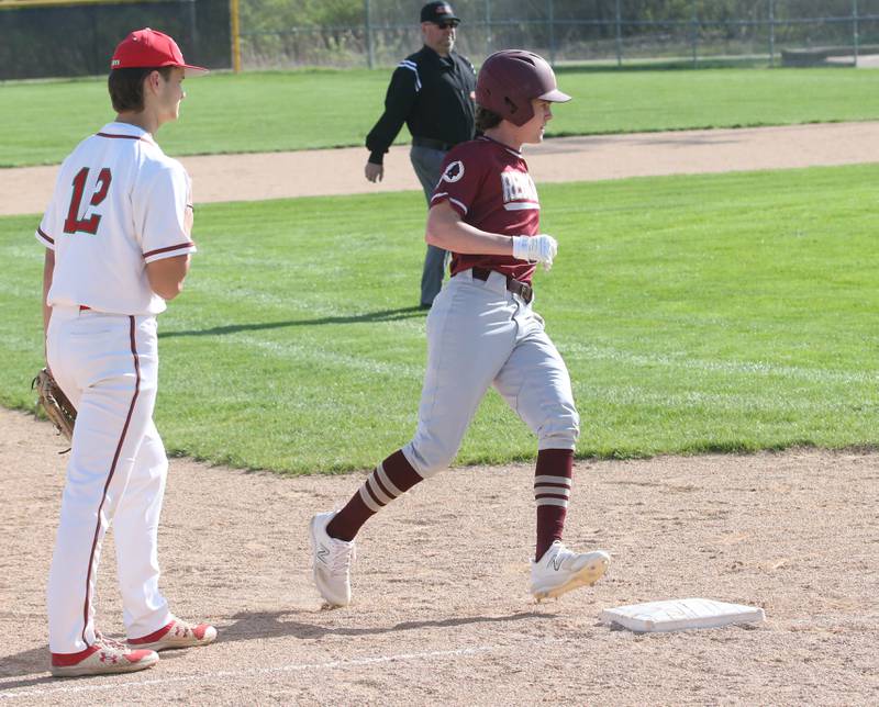 Morris's AJ Zweeres rounds third base while L-P's Brenden Boudreau watches the play on Friday, April 21, 2023 at Dickinson Field in Oglesby.