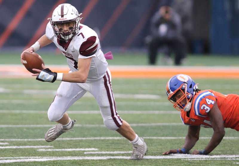 Prairie Ridge's Tyler Vasey scrambles away from East St. Louis' Dominic Dixon during their IHSA Class 6A state championship game Saturday, Nov. 26, 2022, in Memorial Stadium at the University of Illinois in Champaign.
