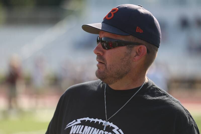 Wilmington head coach Jeff Reents stands on the field at the Morris 7 on 7 scrimmage. Tuesday, July 19, 2022 in Morris.