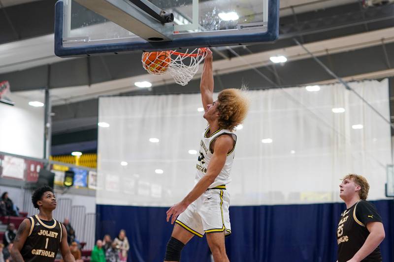 Yorkville Christian's Noah Aguado (22) dunks the ball off of a fast break against Joliet Catholic during a basketball game at Yorkville Christian High School on Monday, January 13, 2025.