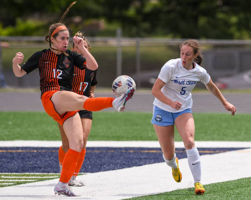 St. Charles East Amanda Stepien (12) ties to keep the ball away from St. Charles North Rian Spaulding (5) during the second half of the sectional title game Saturday May 27th held at West Chicago Community High School.