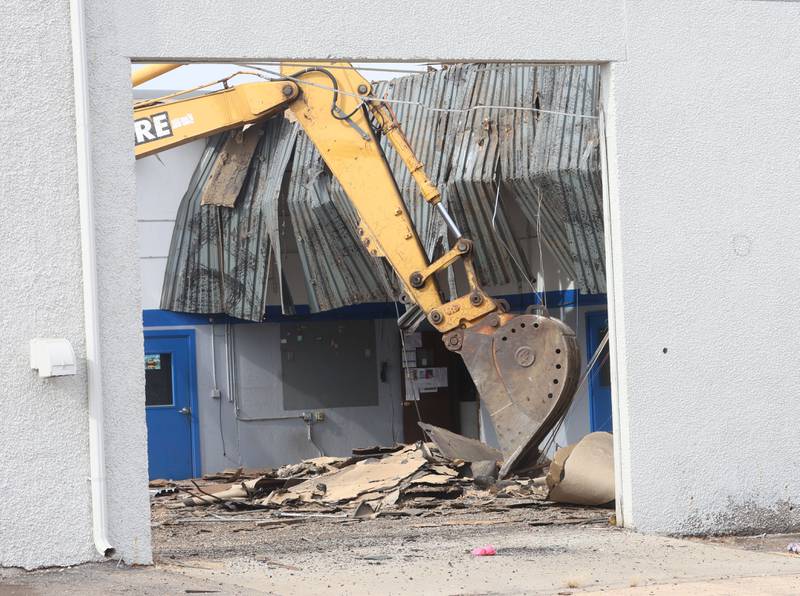 An excavator demolishes a portion of the Bill Walsh Coronet Dodge Chrysler Jeep RAM dealership on Tuesday, Feb. 17, 2026 in Peru.
