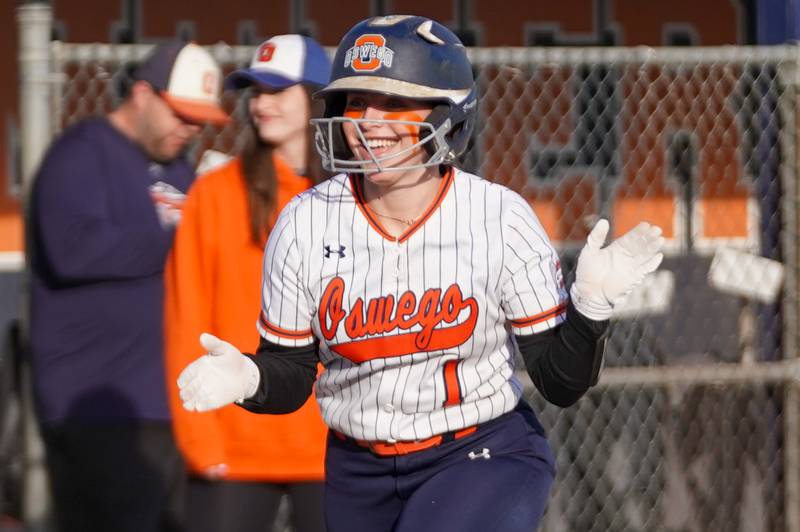 Oswego’s Savannah Page (1) smiles after hitting a three run homer against Downers Grove South during a softball game at Oswego High School on Tuesday, March 19, 2024.
