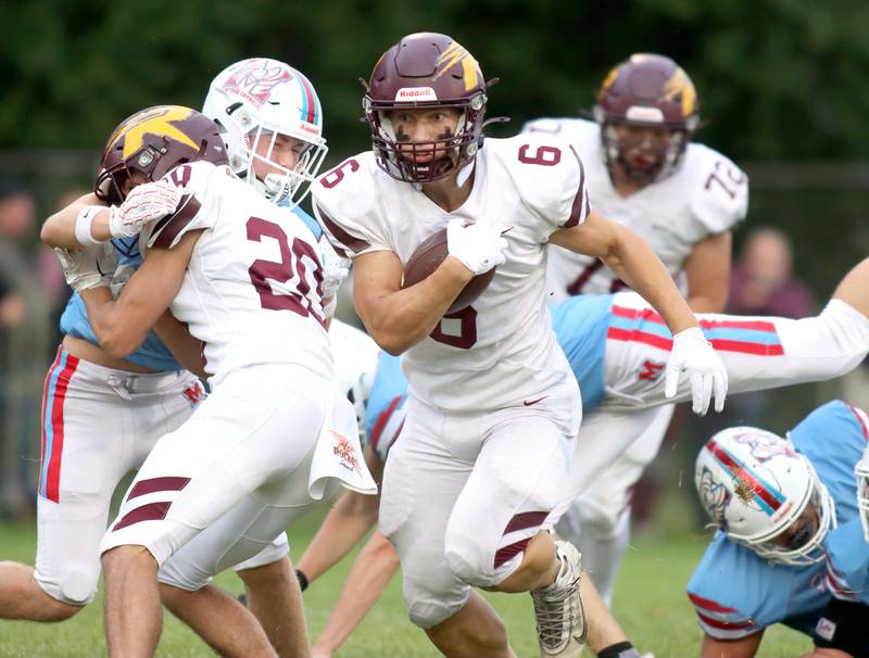 Richmond-Burton’s Hunter Carley sprints to a first-quarter touchdown in varsity football at George Harding Field on the campus of Marian Central High School in Woodstock on Friday, August 29, 2025.