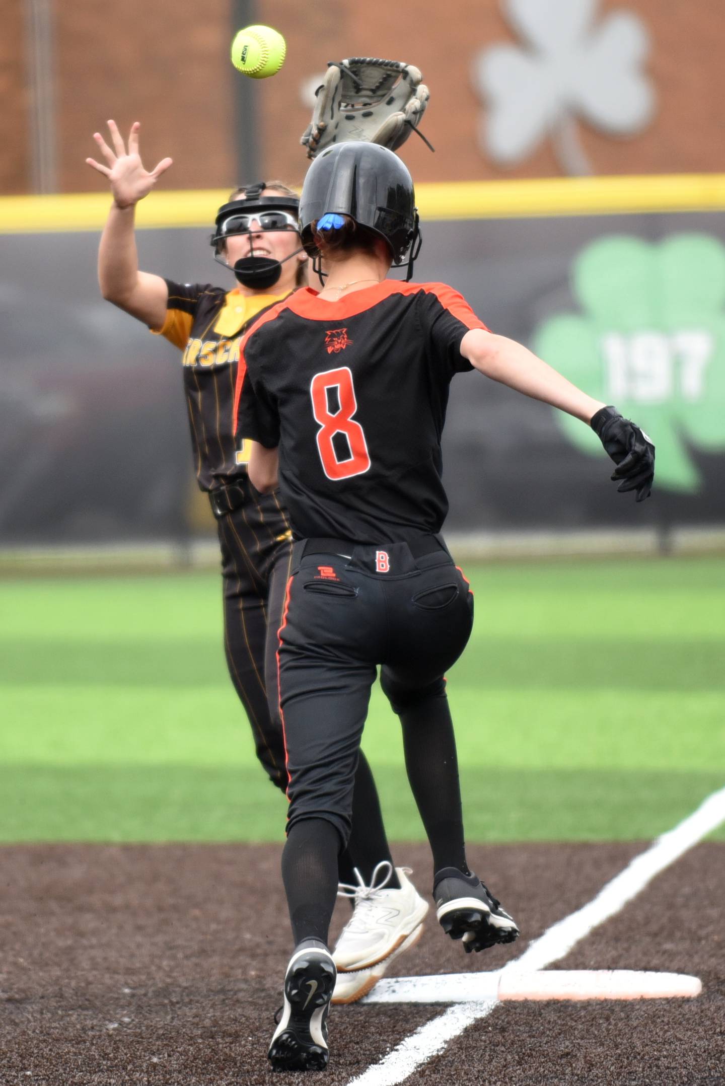Herscher's Abby Overacker, left, attempts to field a throw at first base as Beecher's Elena Kvasnicka runs in during the Class 2A Seneca Sectional semifinals Tuesday, May 27, 2025.