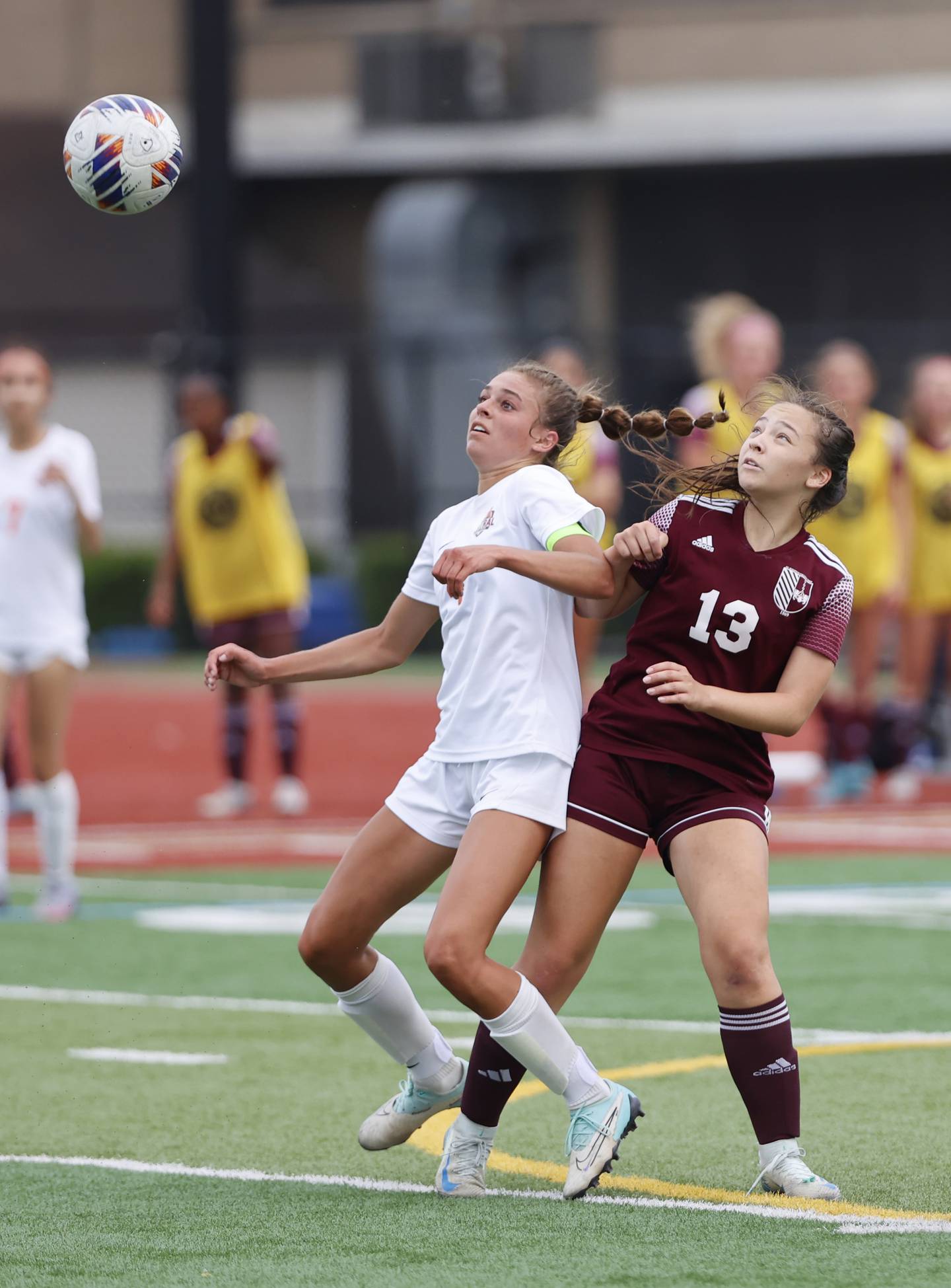 Crystal Lake Central's Hadley Ferrero (4) fights for the ball against St. Ignatius' Lill Garcia (13) during the 2A girl's varsity supersectional soccer match between Crystal Lake South and St. Ignatius high schools on Tuesday, June 3, 2025 in Chicago.