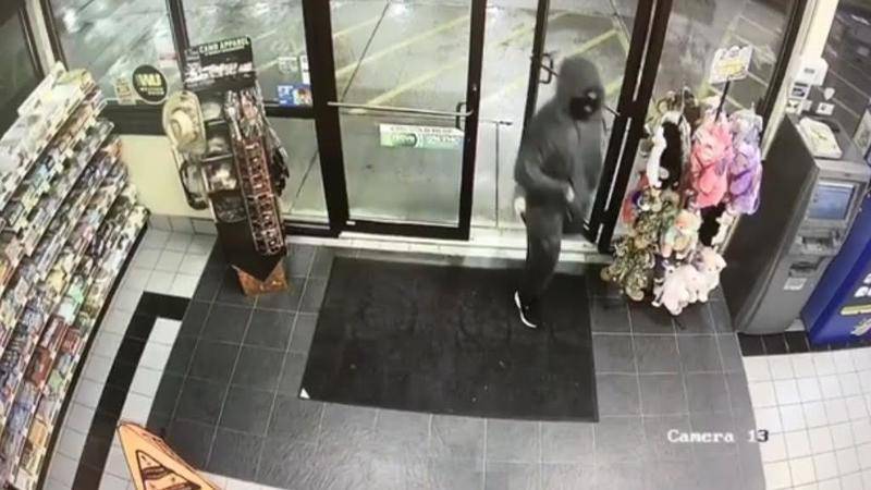 Surveillance video shows a male suspect in a ski mask, grey hoodie with black markings, and grey pants entering the Minit Mart on north Division Street in Morris early Friday morning. Police say the suspect allegedly robbed the store with a knife.
