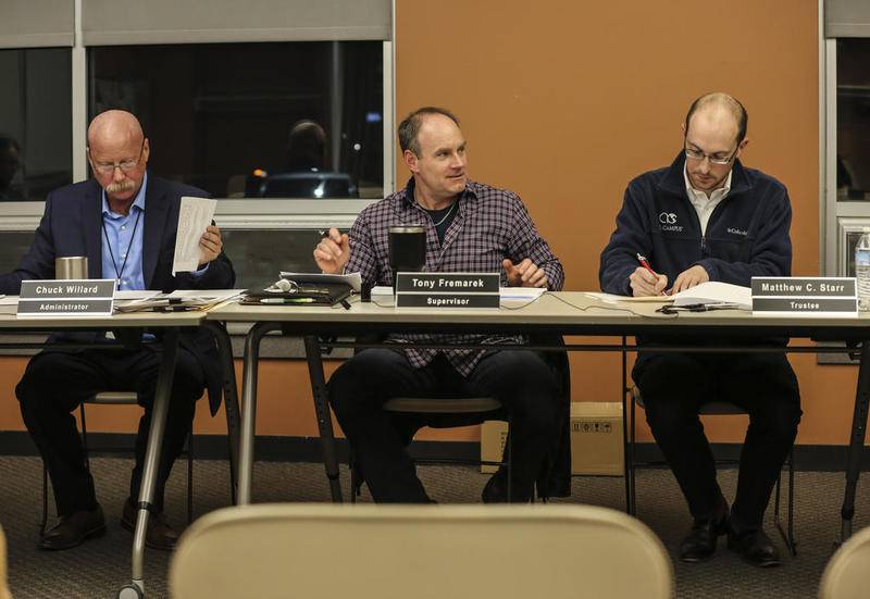 Plainfield Township Supervisor Tony Fremarek (center) speaks to the township highway commissioner Ken Marland on Wednesday at the Plainfield Township Administration Center in Plainfield.