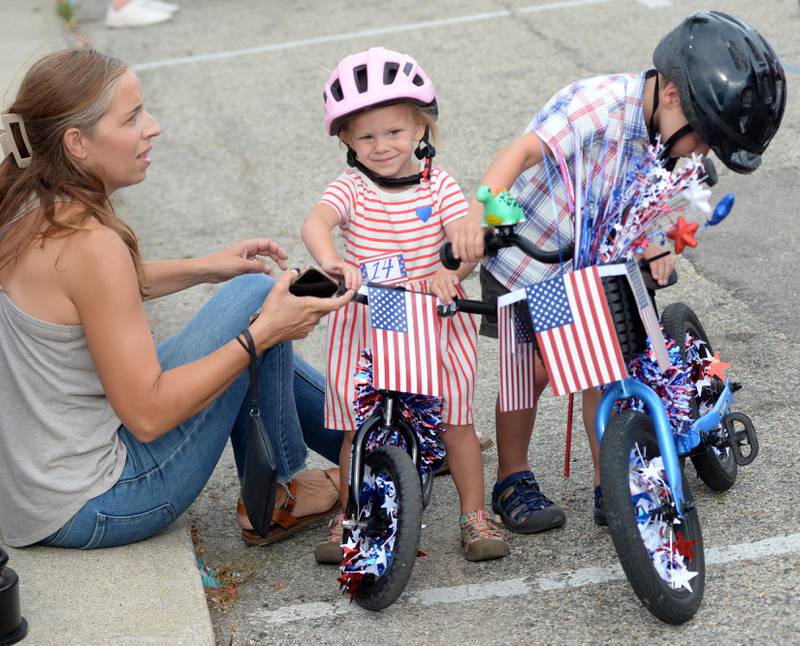 Eleanor Zimmermann, 5, (center) was ready to roll as she waited with her mom, Amanda, before the start of the Let Freedom Ring Kiddie Parade on Saturday, July 5, 2025.
