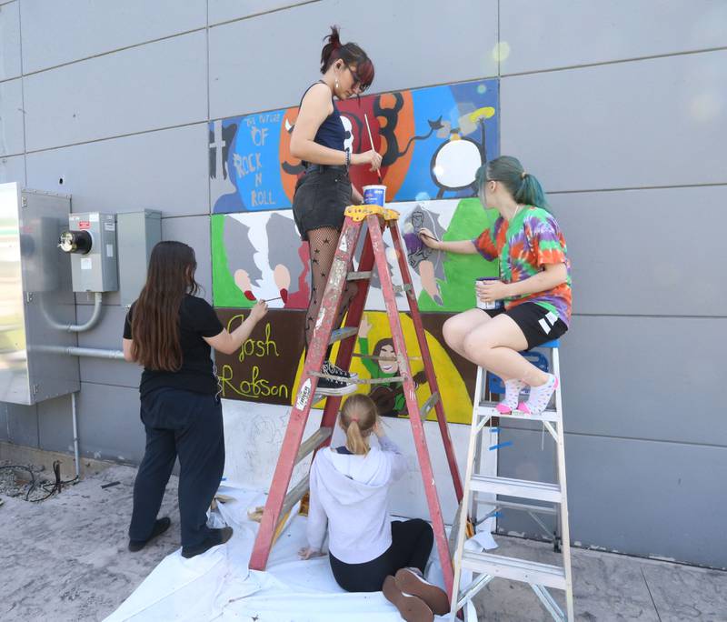 La Salle-Peru Township High School students (from left) Jasmine Arce, Jay McConnil, Mackenzie McCoy and Tiff Grygile draw a musicians’ mural on an exterior wall on Tuesday, May 23, 2023 at Nicks on 6 in La Salle. L-P students worked on a community outreach project to create four murals immortalizing local musicians, on the corner of Bucklin Street and U.S. 6, which houses Nick’s on 6.