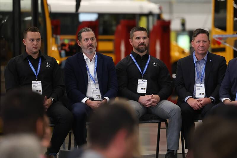 Marc-Andre Page, left, Lion Electric VP of Customer Success, Nicolas Burnet, Lion Electric Executive VP and CFO, Yannick Poulin, Lion Electric Chief Operating Officer and Brian Piern, Lion Electric Chief Commercial Officer, are recognized at the grand opening of the Lion Electric manufacturing facility on Friday, July 21st, 2023 in Joliet.