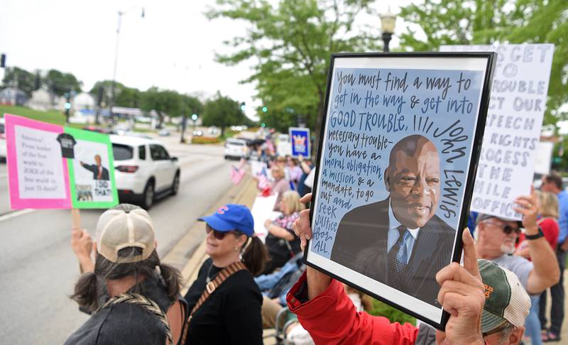 A sign honoring the late John Lewis is held up during the "Good Trouble Lives On" protest in Elgin Thursday.