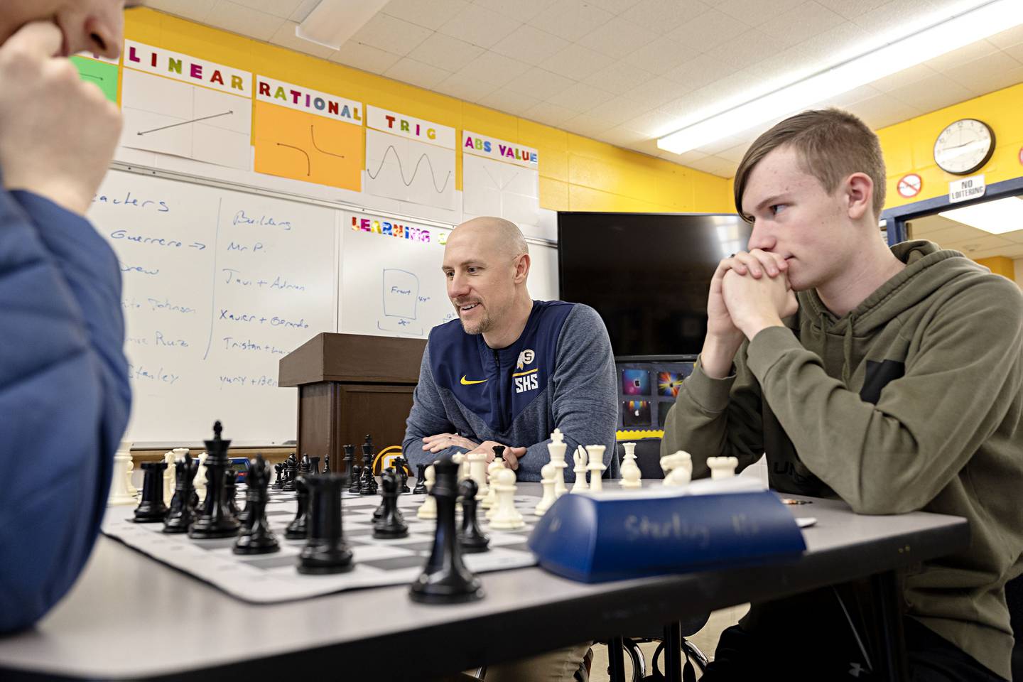 Sterling High School chess instructor Joel Penne plays a team chess game with some of his students during an off season activity hour at the school.