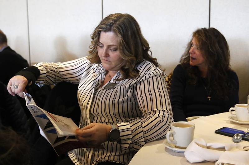 Katie O’Neill, of Heritage Title Company, looks at the State of the Community report while Karen Conley, of Heartland Realtor Organization, listens to a speaker during the Crystal Lake Chamber of Commerce’s State of the Community Luncheon, Friday, Feb. 4, 2022, at D'Andrea Banquets & Conference Center. The annual luncheon feature guest speakers Crystal Lake Mayor Haig Haleblian and Village of Lakewood President David Stavropoulos who spoke about their respective communities.