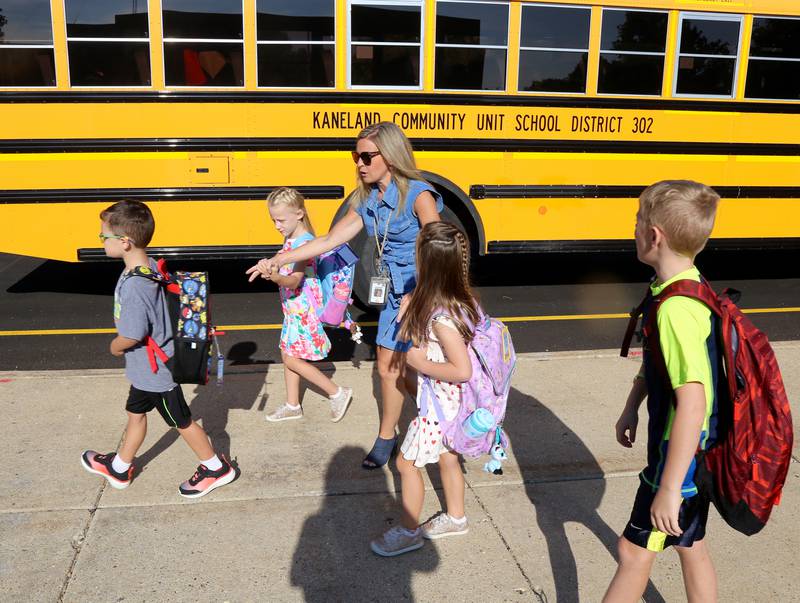 Kelly Johnson, MTSS teacher at Kaneland John Shields Elementary School in Sugar Grove, helps guide kindergarteners to where they line up for the first day of the 2023-24 school year on Wednesday, Aug. 16, 2023.