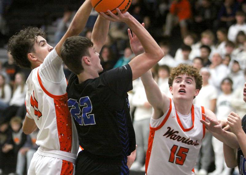 McHenry’s Haydn Schmidt, left, and Parker Ostertag guard Burlington Central’s Joseph Cumpata in varsity boys basketball on Friday, Dec. 5, 2025, at McHenry Community High School in McHenry.