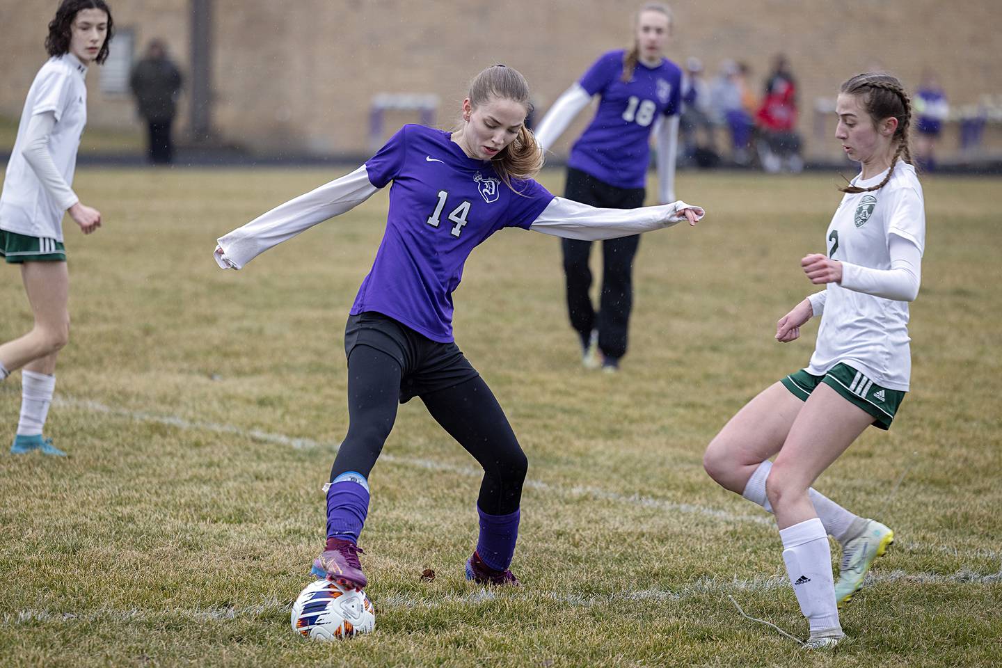 Dixon’s Maggie Van Sickle works against Alleman’s Lindsey Britton Thursday, March 16, 2023.