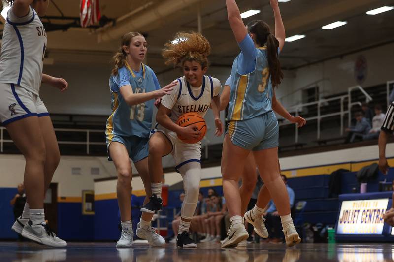Joliet Central’s Nevaeh Wright battles to the basket against Joliet Catholic on Monday, Jan. 6, 2025 in Joliet.