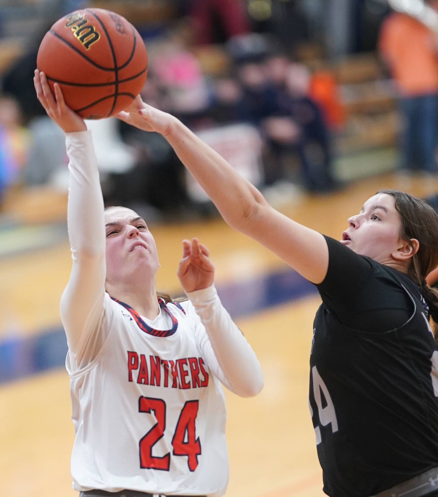 Oswego East's Ava Valek (right) blocks a shot by Oswego’s Kaelyn Stager during a basketball game at Oswego High School on Tuesday, Dec 12, 2023.